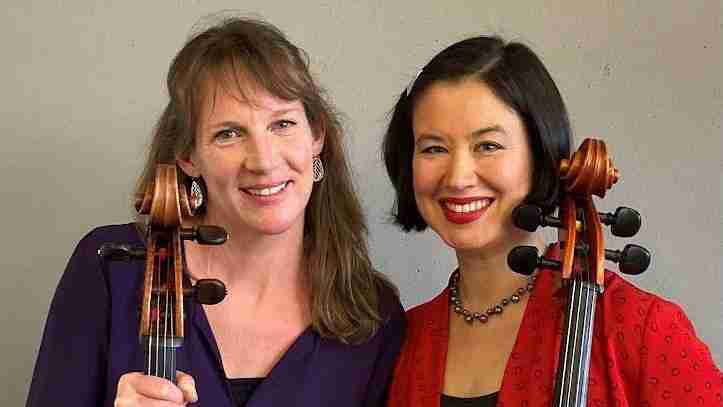 two women holding cellos